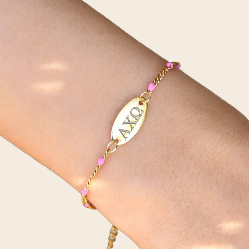 Alpha Chi Omega Sorority Bracelet – Pink Enamel Gold-Plated Chain Style, Modeled on Hand